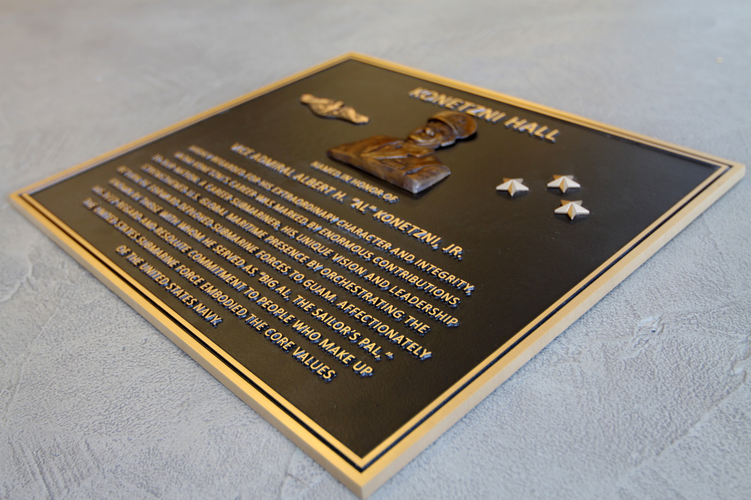 A placard memorializing a person who served in the Navy.