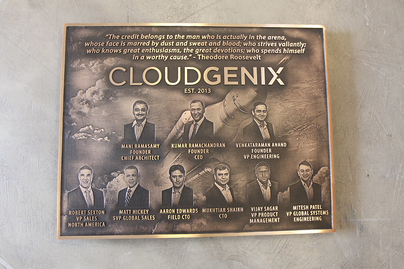Bronze plaque welcome sign with company name, founder, and establishment details