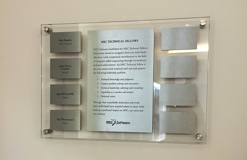 Stainless steel recognition plaques on a glass background