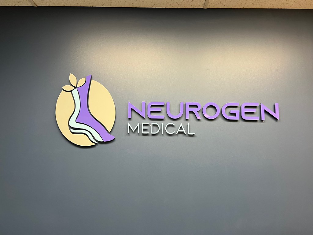 60"w x 3/8" thick acrylic logo Painted in custom Pantone Colors Flush Stud mounts with spacers to "float" each letter off the wall Purple: 66499D Blue: 488FCC Grey: 757575