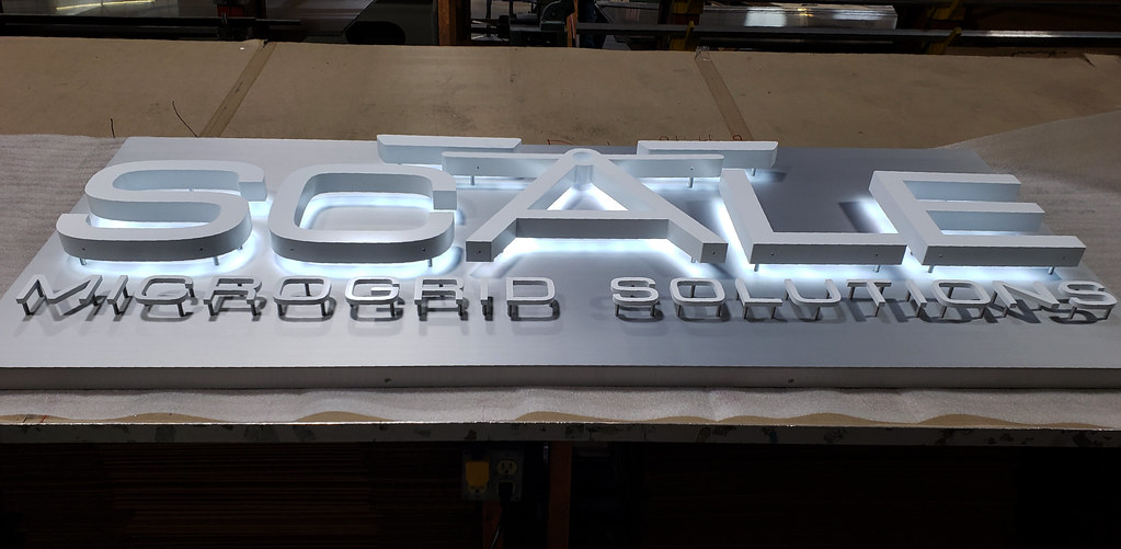 72" x 30" x 2" deep fabricated panel with raised Fabricated LED lighted Custom logo shape and lettering Tagline lettering to be nonilluminated cut aluminum installed with spacers for 'floating' look