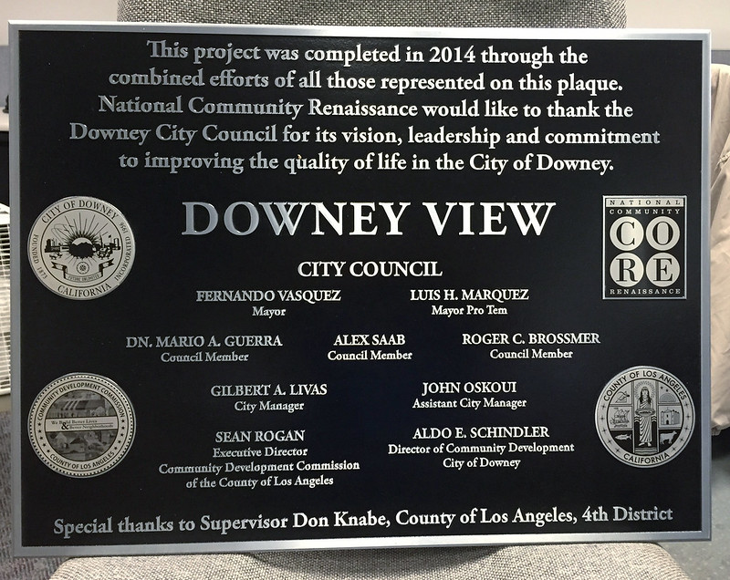 Cast aluminum city council plaque with four etched seals inset into the face