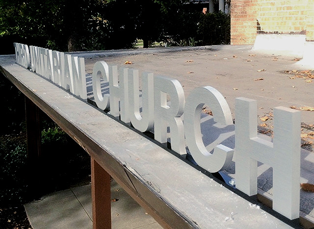 Bottom rail mounted clear anodized cast aluminum building identification sign