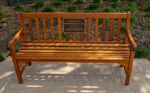 Bronze bench plaque with brown background and blind studs on back for customer mounting