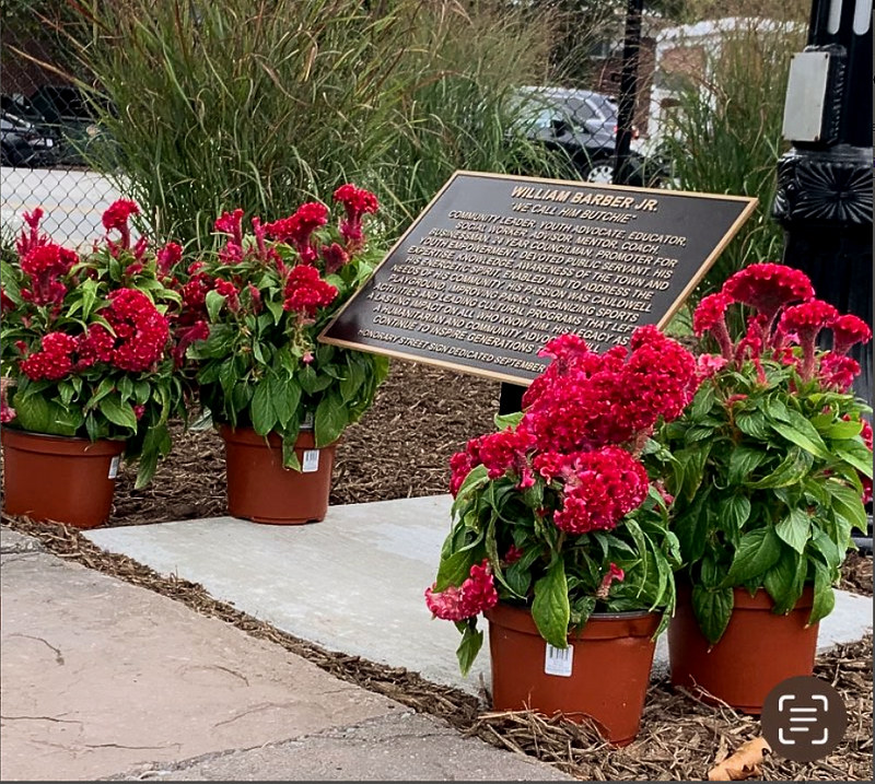 Bronze plaque mounted on a black metal post