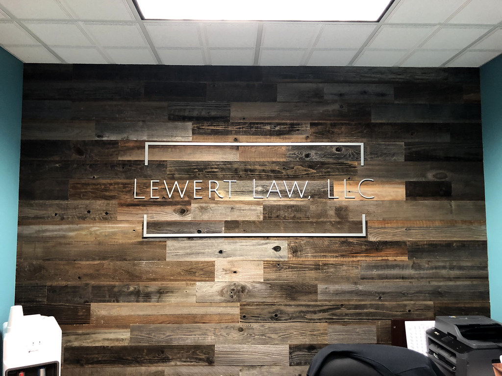 Brushed Aluminum logo sign on customer pallet wall