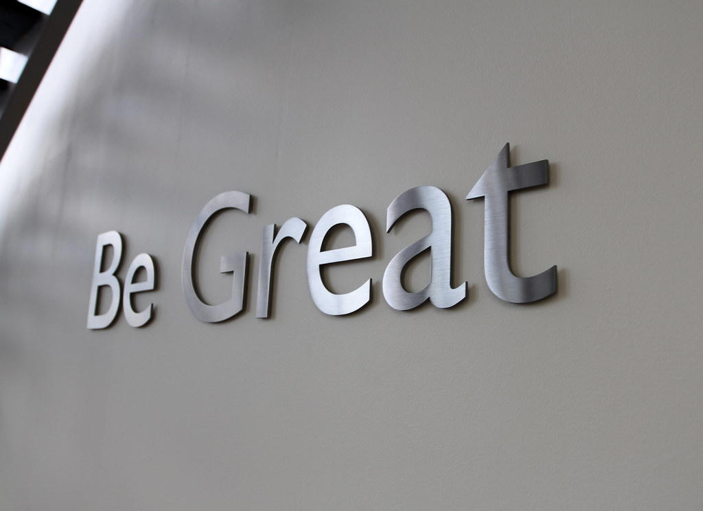 Cut Stainless Steel Letters in brushed finish installed on interior drywall lobby with spacers