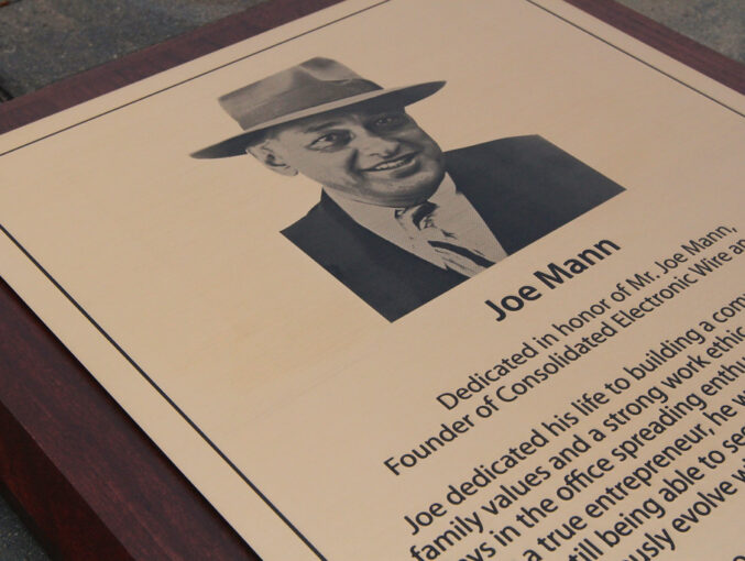 Detail etched bronze plaque with halftone image on wooden backer