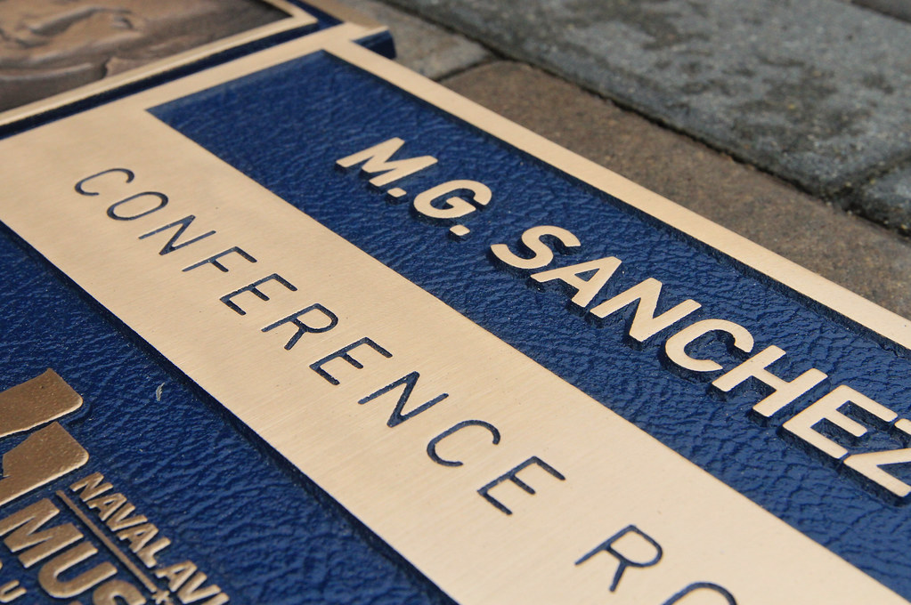 Detail of conference room dedication sign with custom logo photo relief image blue leatherette background