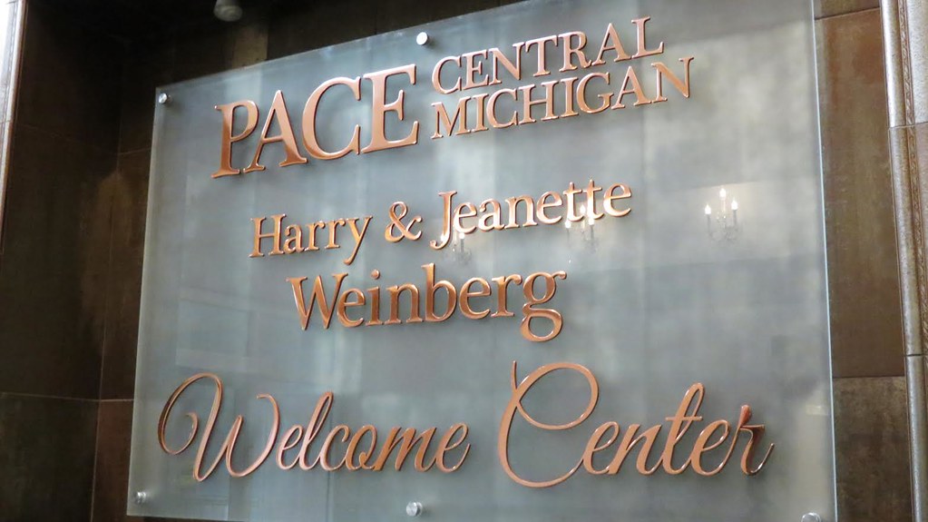 Polished copper lettering assembled on frosted glass panel