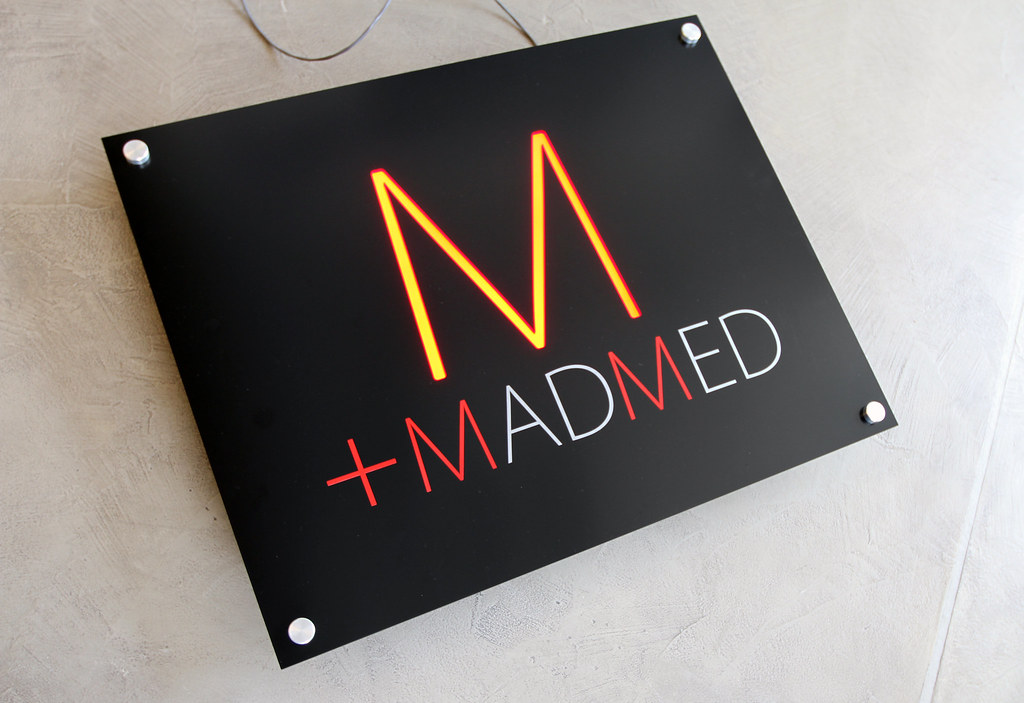 Reverse cut through aluminum panel with colored acrylic backer for lighting to show through face