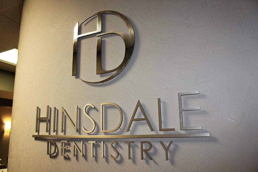 Stainless steel custom logo and lettering signage for dental office lobby