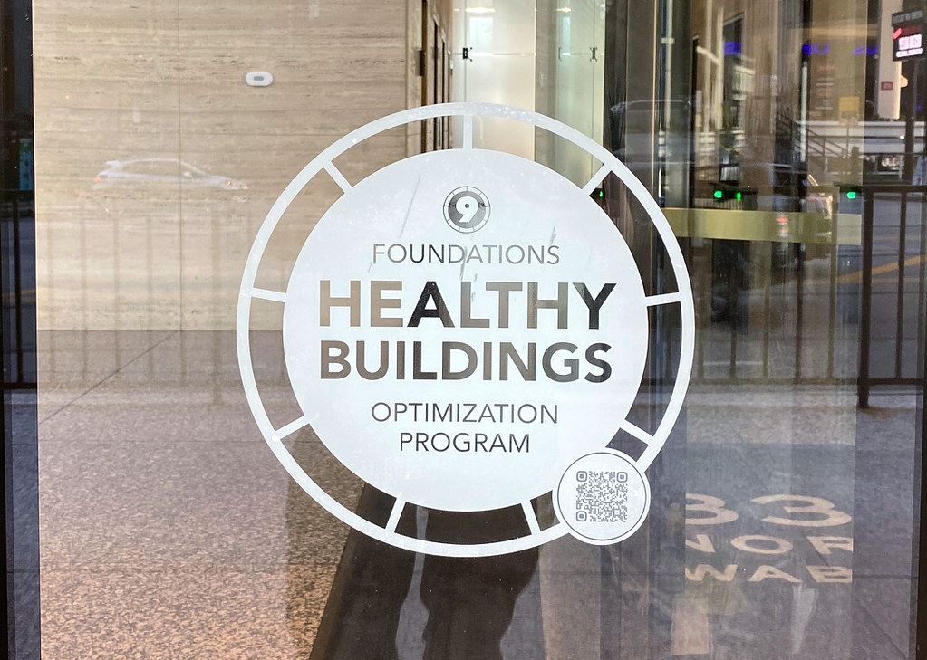 White vinyl logo with QR code for outdoor glass door signage