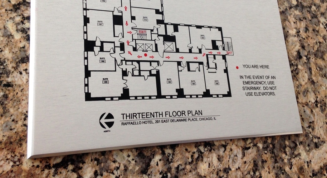 Zinc plaque displaying fire evacuation plan for a hotel