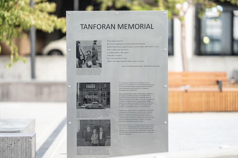 A memorial plaque at the Tanforan Memorial, engraved with images and storytelling.