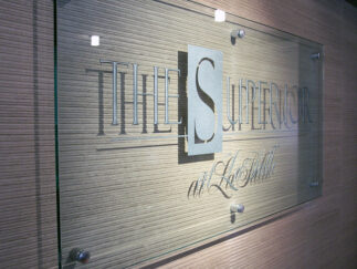 A clear glass sign created by Impact Signs.