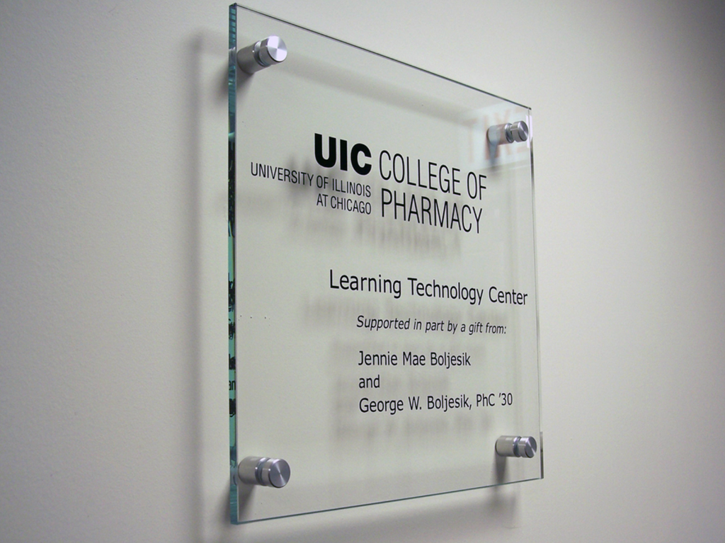 An etched and paint-filled logo in thick clear glass.