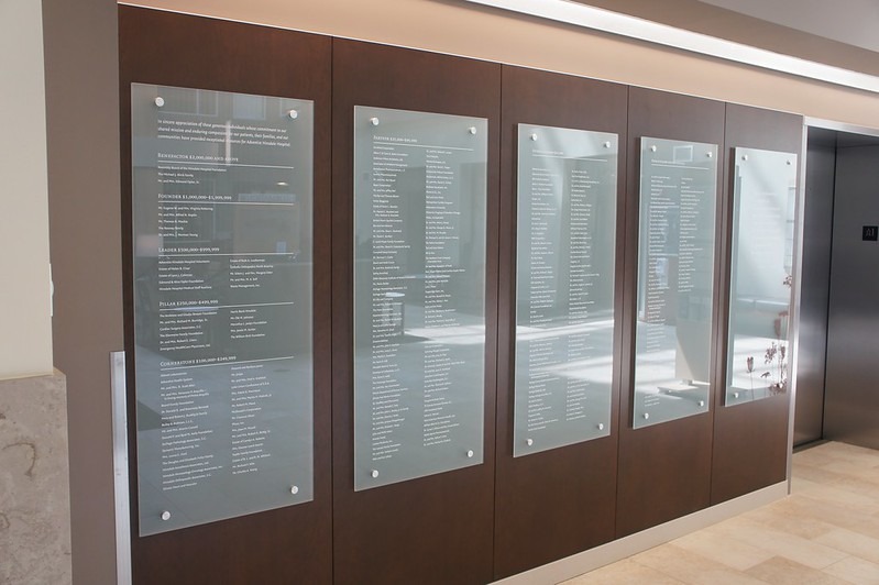 Five etched glass panels on display as a donor recognition wall created by Impact Signs near Chicago IL.